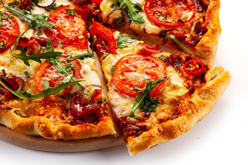 Pizza with ham, rucola, and vegetables on white background