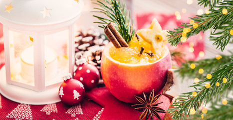 roast apple in romantic setting with candles and bokeh and cinnamon and fir