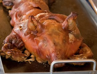 Suckling pig fresh from the grill served on a plate
