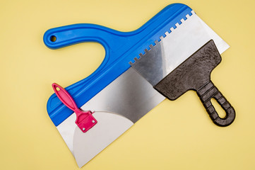 Spatula for different works on a yellow background.