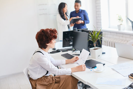 Business meeting of creative international partners, togetherness. Friendly business people in office discussing business ideas