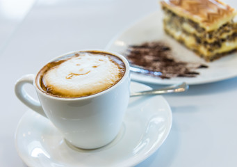 Cup of coffee and cake on the table