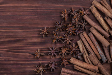 Star anise, cinnamon and roasted coffee beans. Aromatic spices on wooden background. Top view. Close up. Seasoning ingredients for cooking or baking