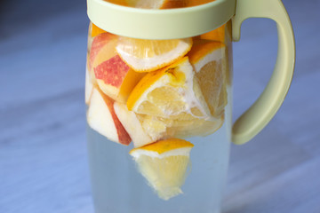 apple orange drink in glass jug close up