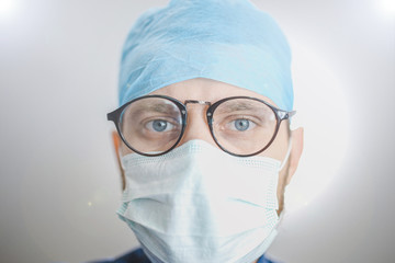 bottom view of a young surgeon looking at camera. Surgical operation in the hospital.