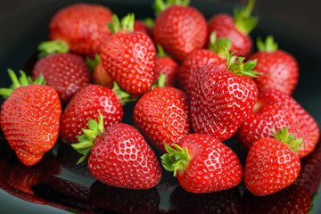 Strawberry closeup. Macro image of fresh strawberries on dark background