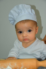 Cute baker in kitchen at home