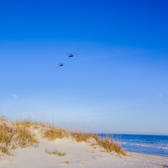 Fototapeta premium Dunes with helicopters in sky