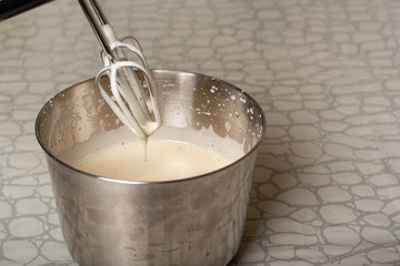 cooking dough for a pie using a mixer. mixer whisk in the dough