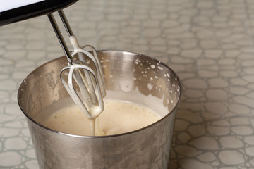 cooking dough for a pie using a mixer. mixer whisk in the dough