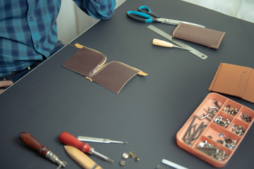 leather wallets on a black background with space for an inscription. Leather craft concept.