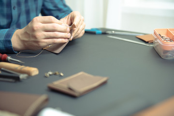 leather wallets on a black background with space for an inscription. Leather craft concept.