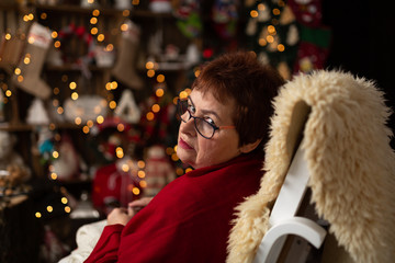 Grandma sews to knit in a Christmas arrangement.