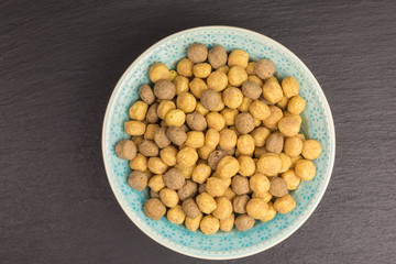 sweet puffed corn balls with peanut butter in a bowl