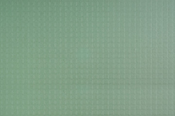 Pale green textured background with square grid embossed
