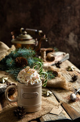 Fototapeta na wymiar ceramic mug with hot cocoa, chocolate or coffee with whipped cream and christmas candy canes