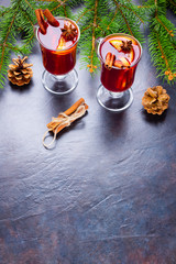 Mulled wine in glass mug with spices. Glasses of mulled wine with cinnamon, anise and fir tree...