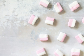 Marshmallows marshmallows isolated on light gray stone background. Top view flat lay background.