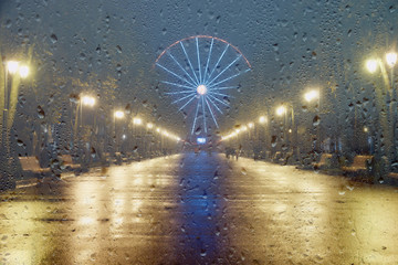 Autumn night rain background, ferris wheel, rain in the park, autumn weather