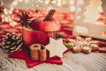 christmas baked apple for christmas in christmas decoration with cinnamon stick and orange and...