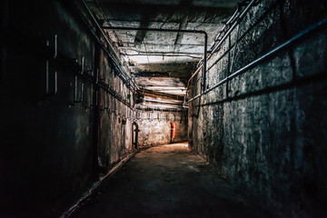 scary abandoned industrial corridor with pipes
