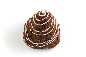 Chocolate cake poured with white chocolate and sprinkled with cocoa isolated on a white background. Closeup