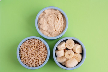 ingredients for making smoothies in bowls - banana, hummus and pine nuts