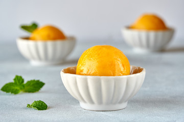 Fototapeta na wymiar Mango ice cream sorbet with mint leaves 