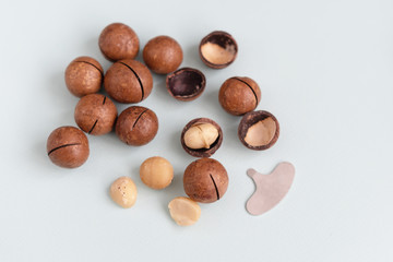 macadamia nuts and a metal key for opening nuts. nutritious and healthy snack.