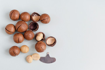 macadamia nuts and a metal key for opening nuts. nutritious and healthy snack.