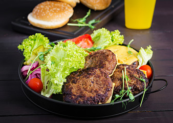 Burger cooking - burger with beef,  tomato, cheese, pickled cucumber and red onion on plate