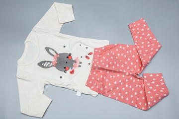 Childrens girls pajama set on grey background. Top view - 301835138