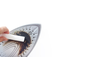 Cleaning the iron with a special pencil. burnt iron for ironing. stain of burnt adhering fabric on the iron. copyspace