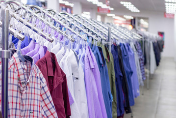 Clothes hang on a shelf . Cloth Hangers with Shirts. Mens business clothes. clothing supermarket