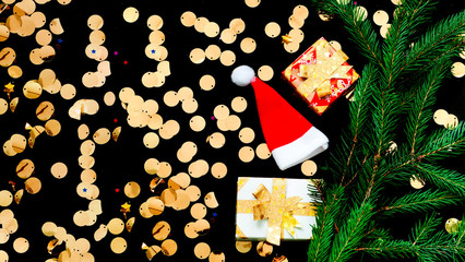 Christmas presents on black background with sparkles. Blurred effect. Close-up
