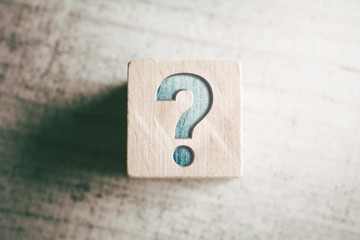 Question Mark On A Wooden Block On A Table