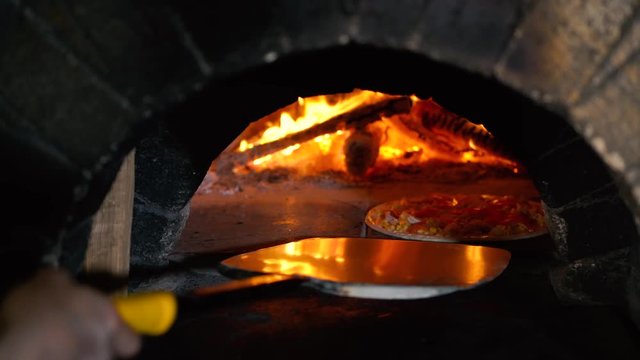 Making authentic Italian pizza in the stone oven stove