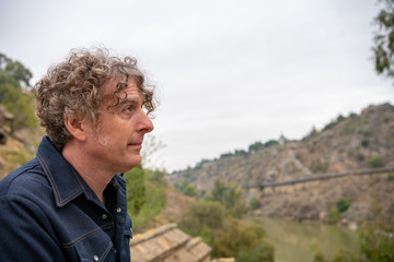 Portrait of a man on vacation exploring the hidden trails around the historical town of Toledo, Spain.