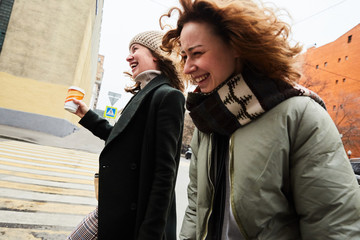 Two young girls walking around the Moscow city extremely happy and dynamic 