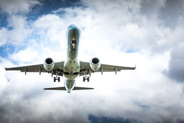 Jet airplane flying in the cloudy skies