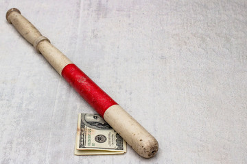 vintage old police index stick with corruption dollars, front and background blurred