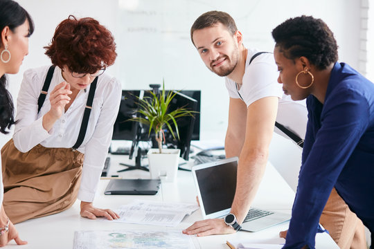 Attractive man look at camera during happy business meeting in office