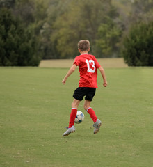 Boy jumps to control the ball
