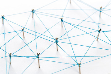 A large grid of pins connected with string. Communication, technology, network concept. Network...