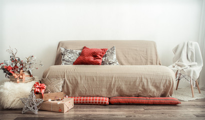 The modern interior of the living room is decorated for the Christmas holiday.