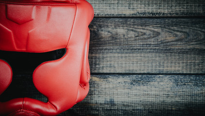 Boxing helmet on wooden background. The concept of sport and active leisure. On the table lies a...