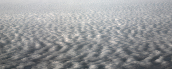Clouds and sky as seen through window of an aircraft