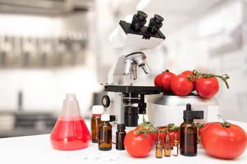 microscope and some tomatoes and natural drugs in a laboratory