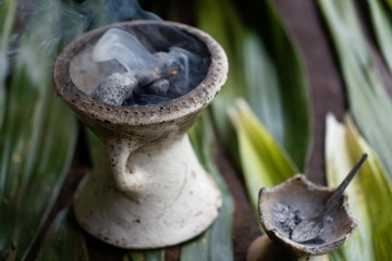 Incense burner with green leaves
