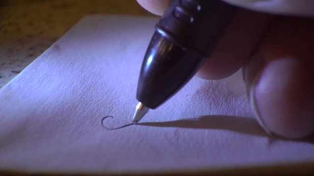 write a love letter with a pen on paper, close-up, macro